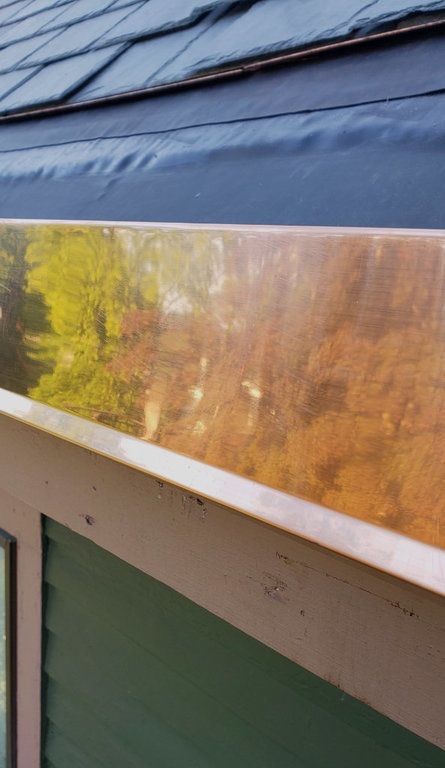 Copper edging on outside of gutter.